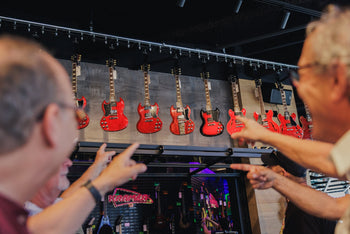 Customers pointing at Gibson SG models at the Gibson Garage Miami