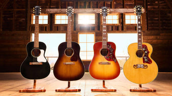 Gibson L-00, J-45, Hummingbird and SJ-200 in a wooden room with windows for the Gibson acoustic shapes buyers guide