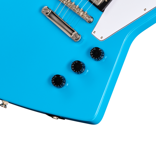 Close-up of a blue electric guitar with white pickguard on a white background