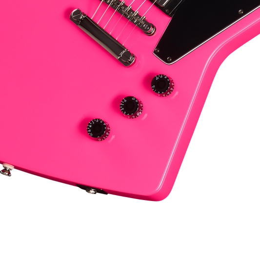 Close-up of a pink electric guitar with a white background