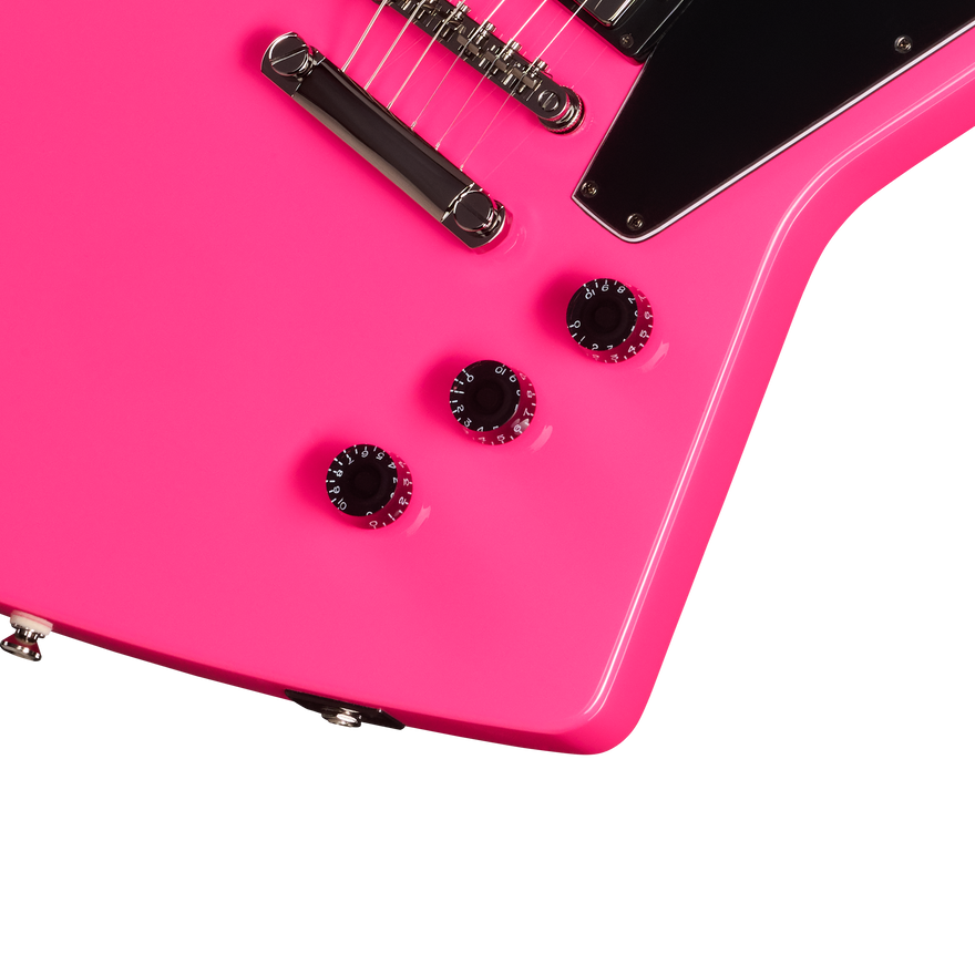 Close-up of a pink electric guitar with a white background