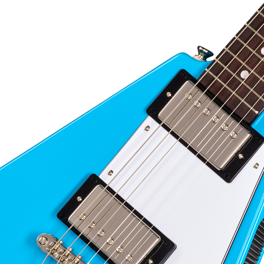 Close-up of a blue electric guitar with a white pickguard on a white background