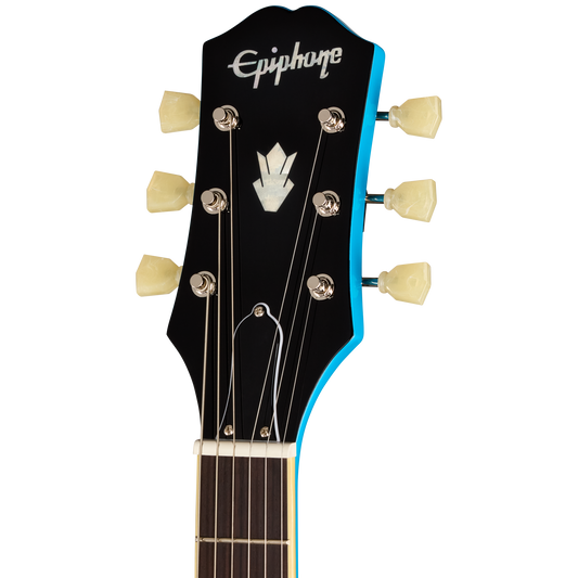 Close-up of the headstock of an Epiphone electric guitar, showing the black headstock with a bright blue edge, white Epiphone logo, and six cream-colored tuning pegs against a white background.