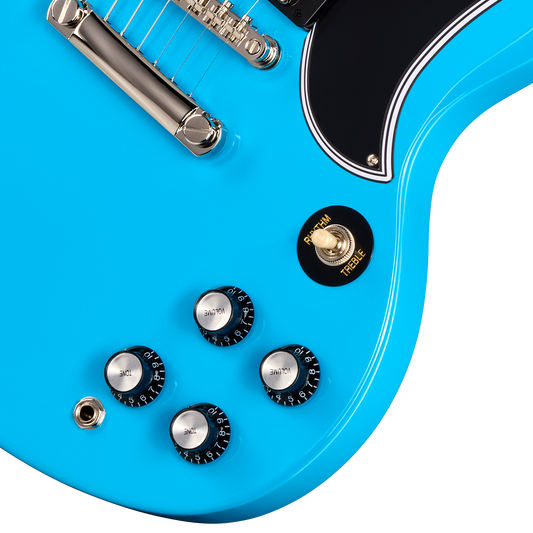 Close-up of a bright blue electric guitar body showing the bridge, pickups, control knobs, and a black toggle switch.