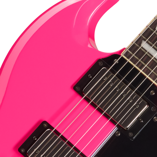 Close-up of a pink electric guitar with a black pickguard on a white background