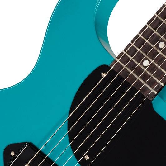 Close-up of a turquoise electric guitar with a white background