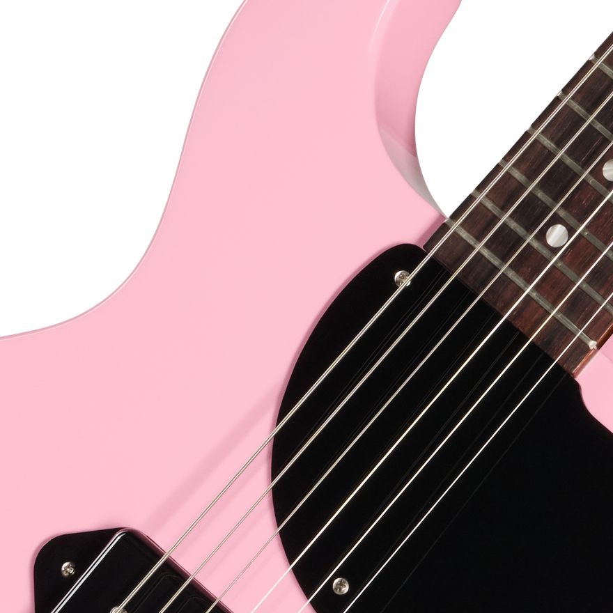 Close-up of a pink electric guitar with a white background