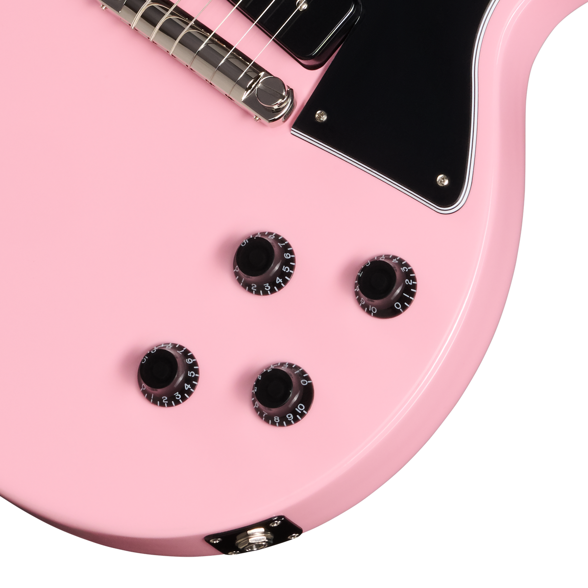 Close-up of a pink electric guitar with black pickguard and tuning pegs.
