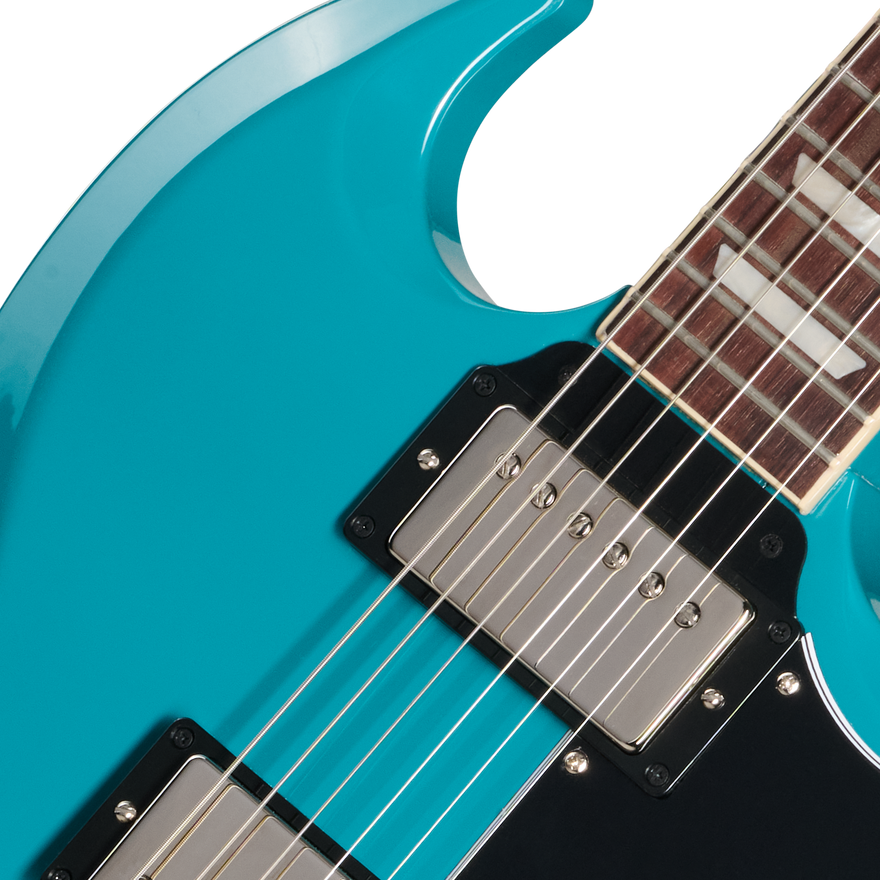 Close-up of a turquoise electric guitar with a focus on the neck and body.