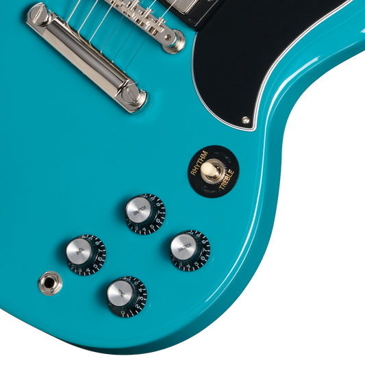 Close-up of a turquoise electric guitar with control knobs and tuning pegs on a white background