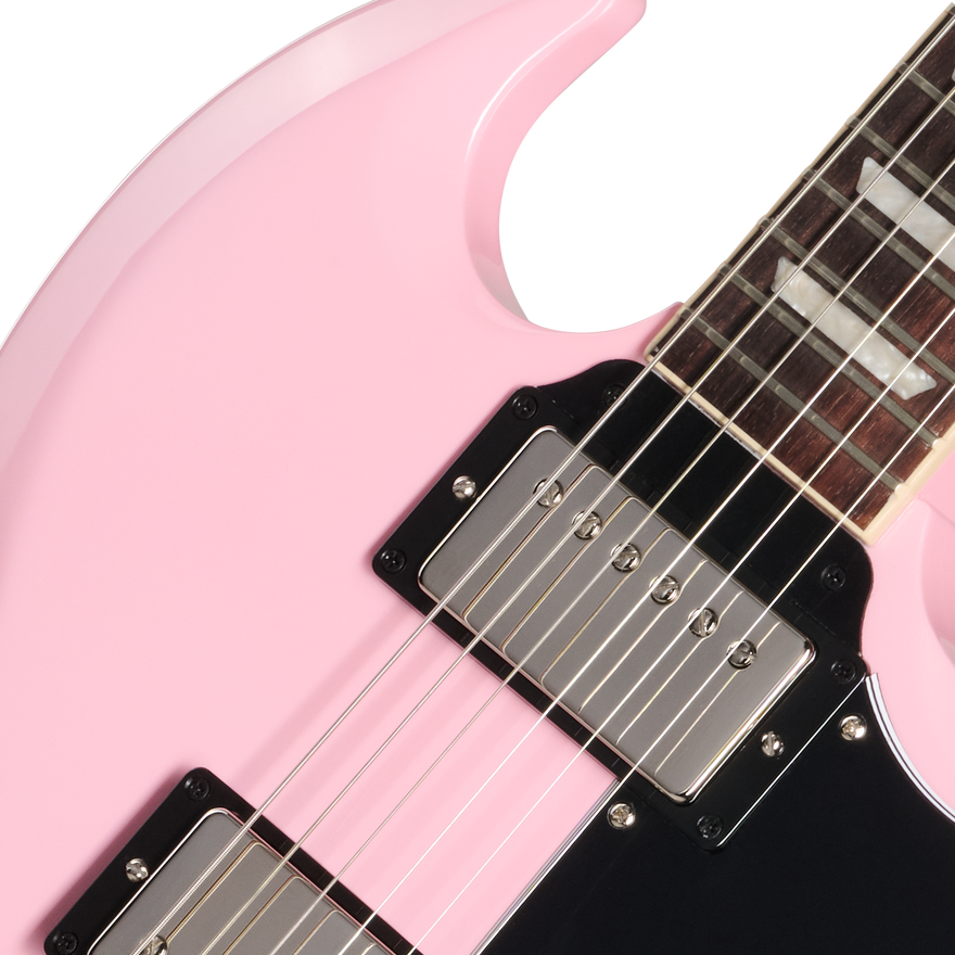 Close-up of a pink electric guitar with a white pickguard