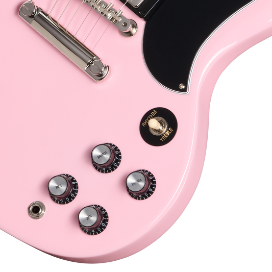 Close-up of a pink electric guitar with control knobs on a white background