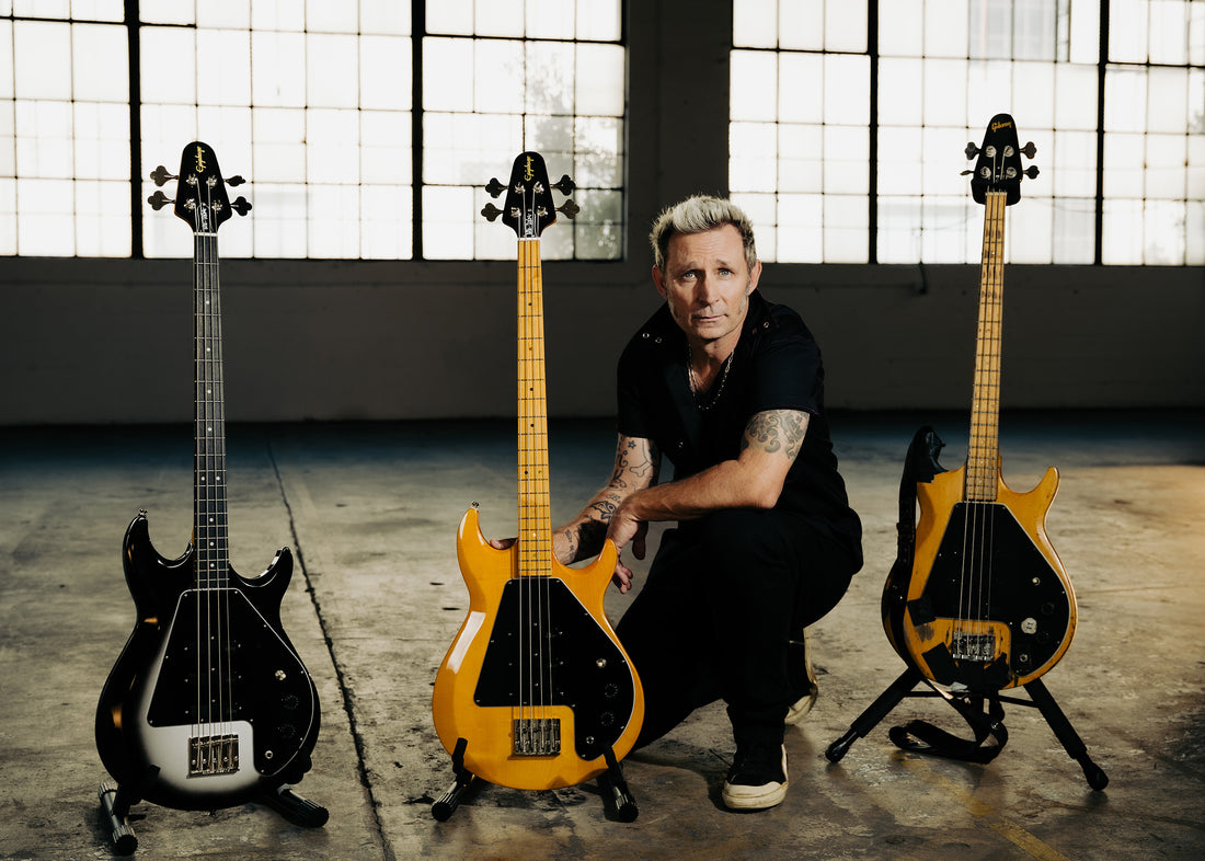Mike Dirnt with his new Epiphone signature bass models and his original Gibson G-3
