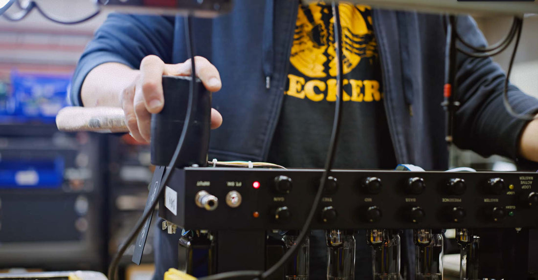A person beats on a MESA/Boogie amp with a hammer to test the chassis